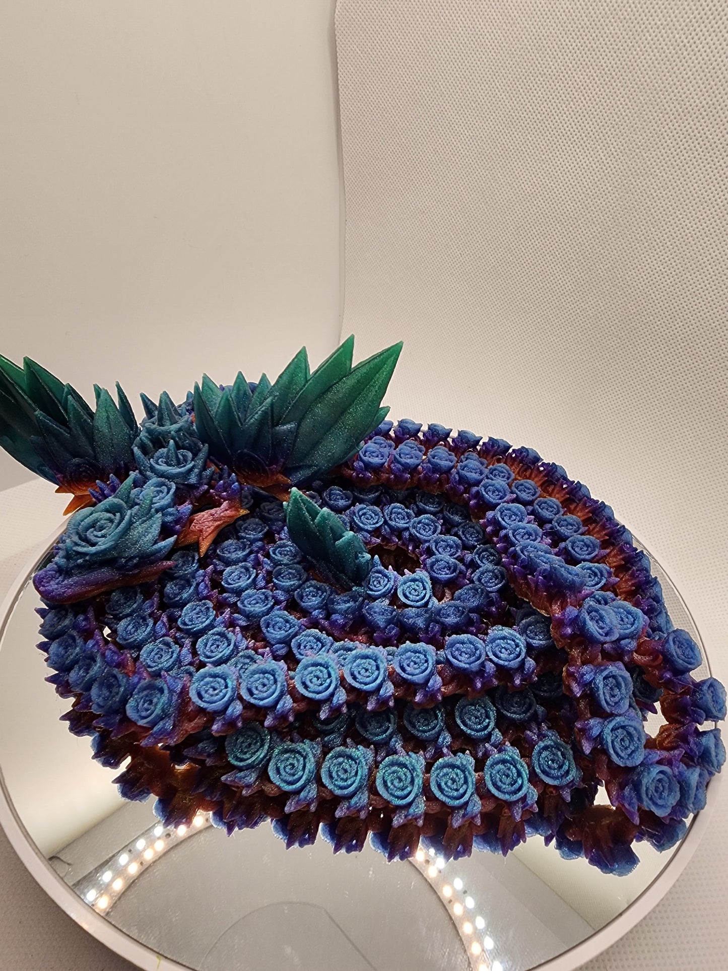 3D printed articulated extra long Rose Dragon with color matching wall mount.