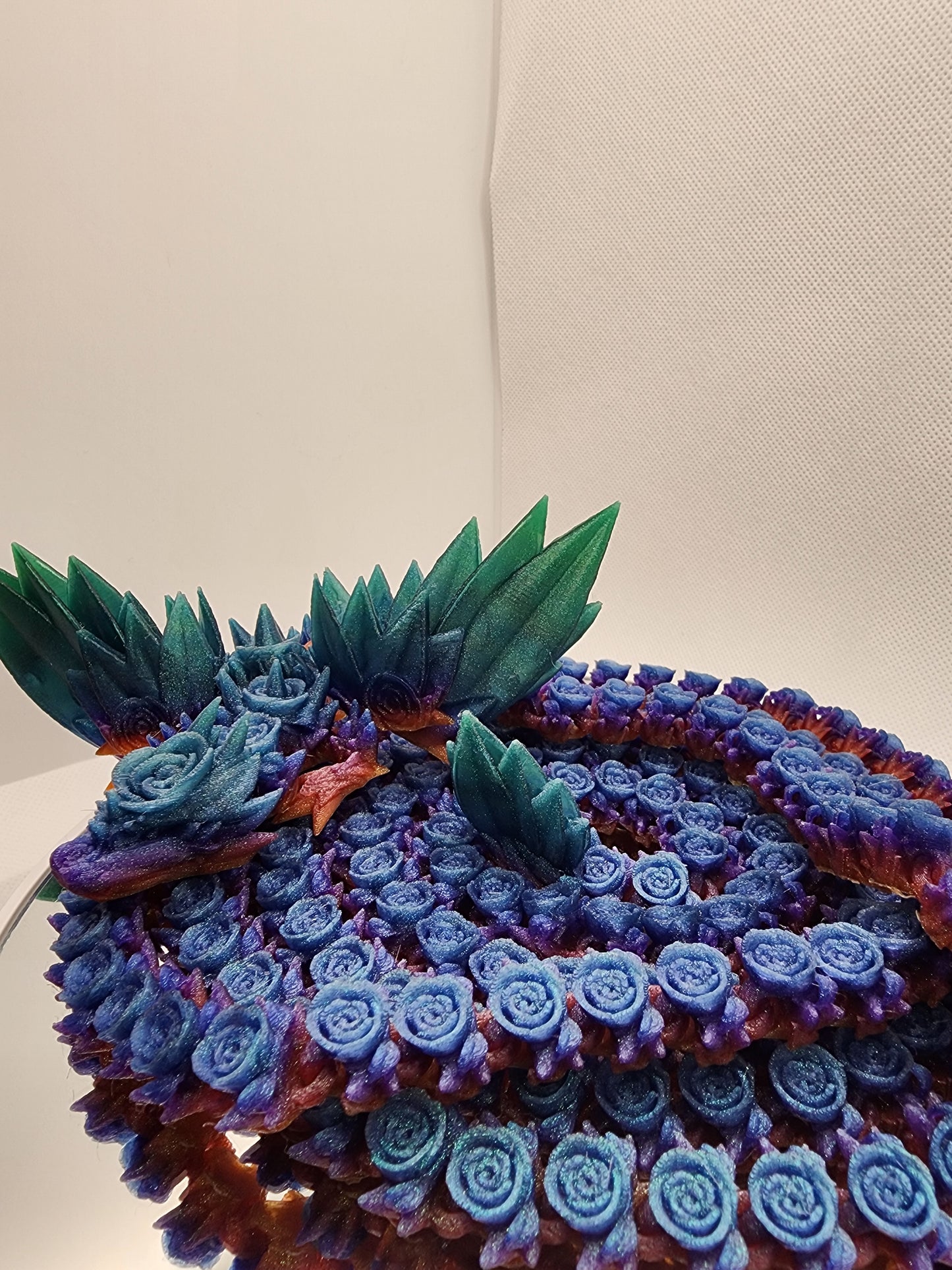 3D printed articulated extra long Rose Dragon with color matching wall mount.