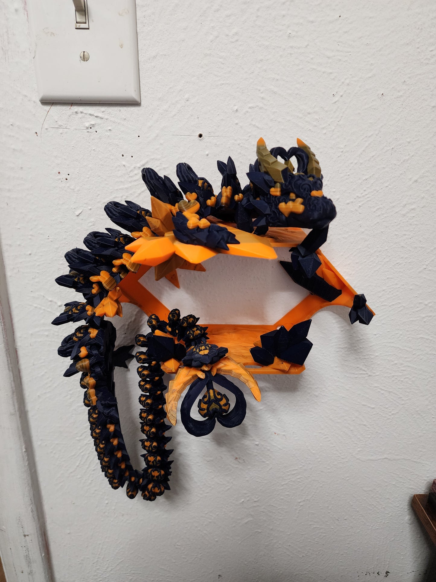 3D printed articulated Light Heart Dragon with custom color matching wall mount.