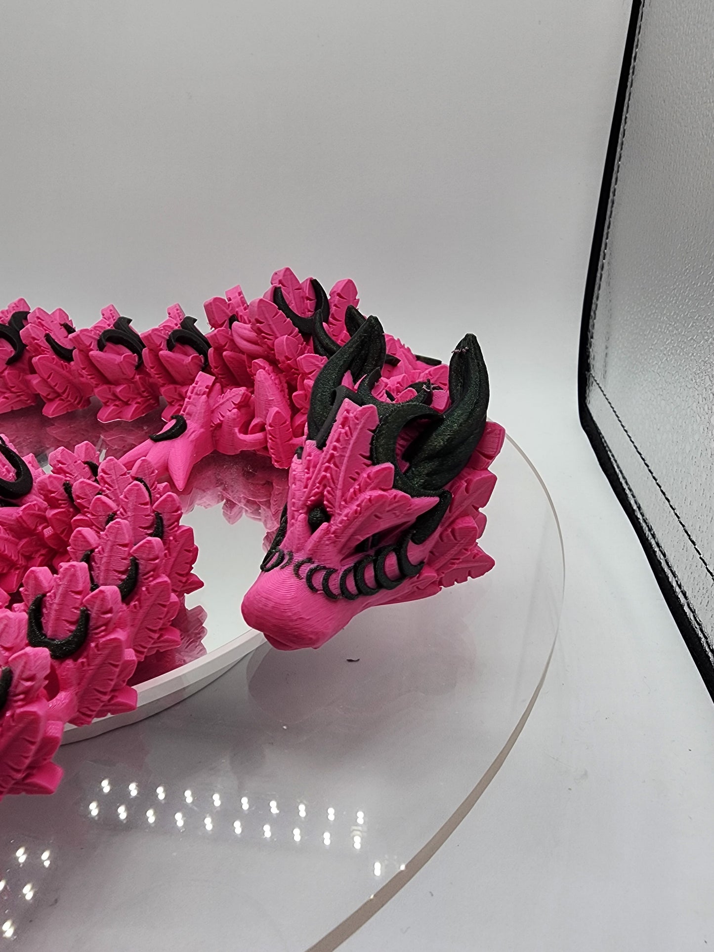 3D printed articulated Lunar Dragon with color-matching custom wall mount.