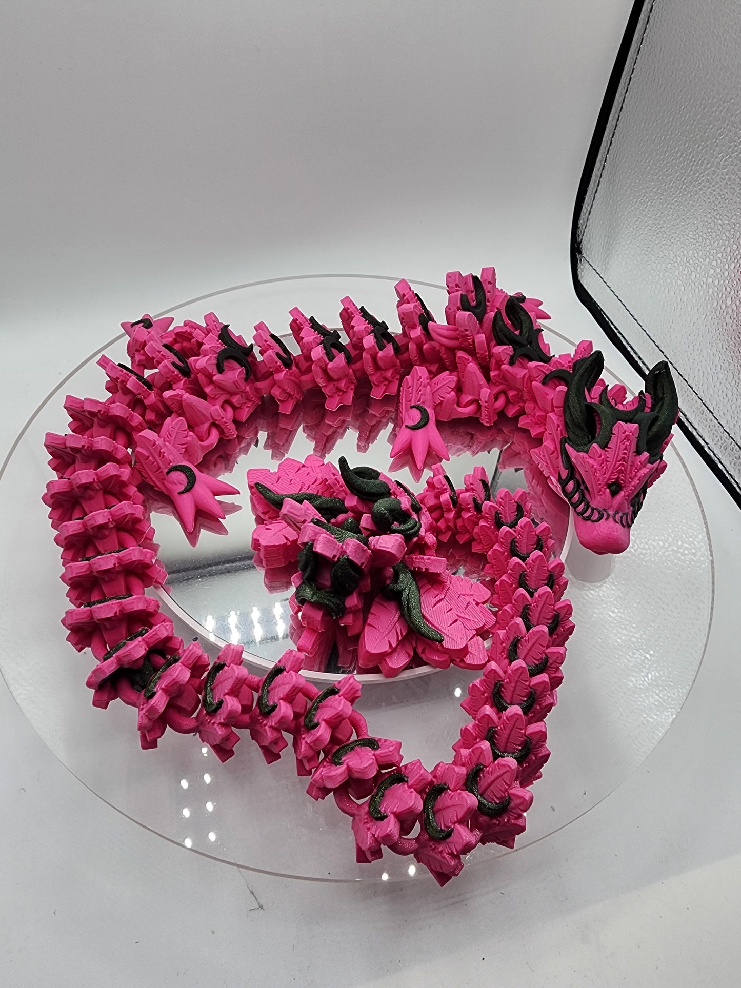 3D printed articulated Lunar Dragon with color-matching custom wall mount.