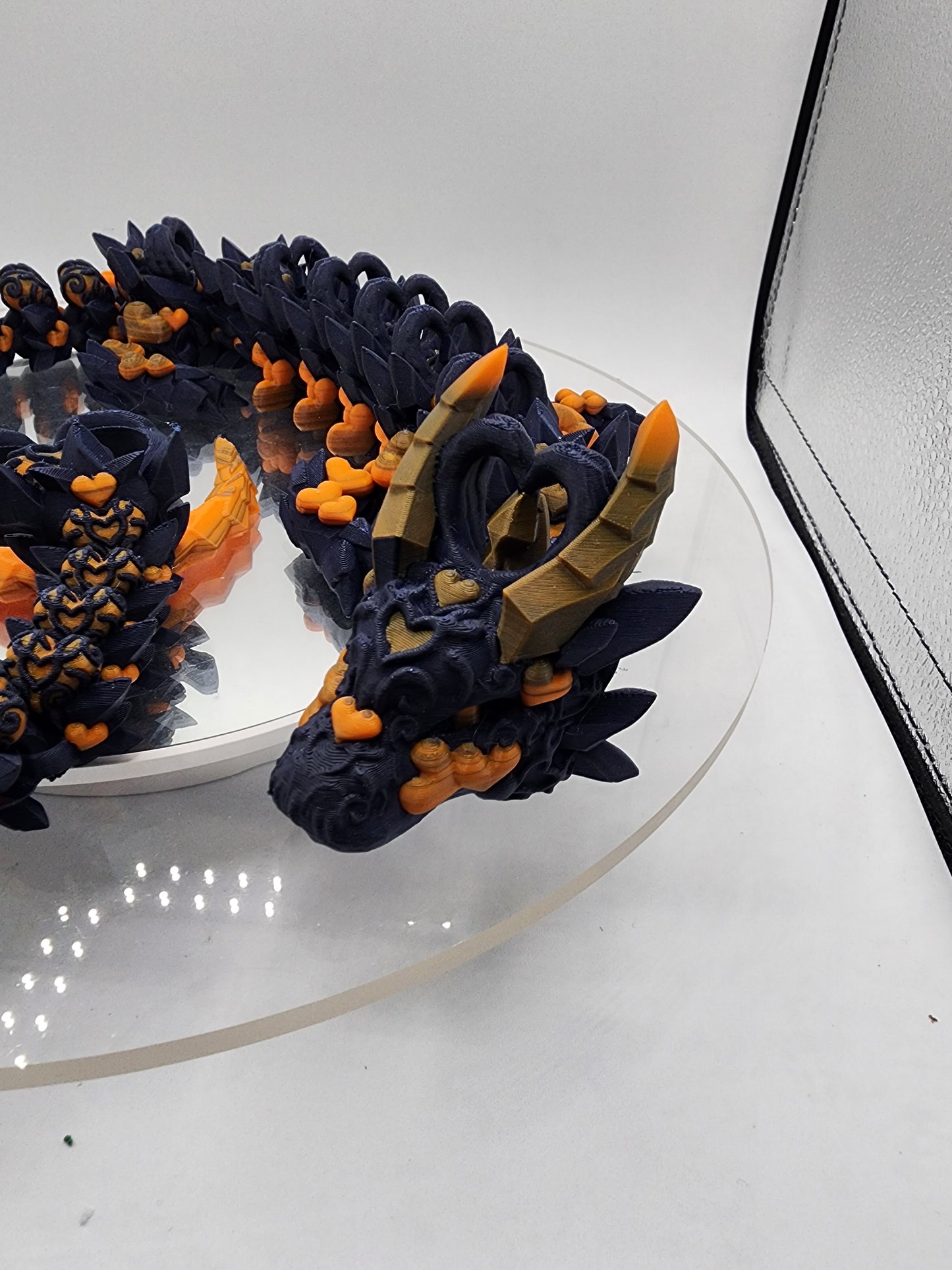 3D printed articulated Light Heart Dragon with custom color matching wall mount.