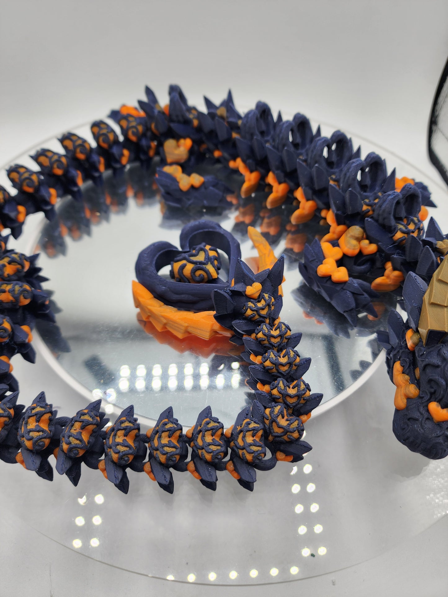 3D printed articulated Light Heart Dragon with custom color matching wall mount.
