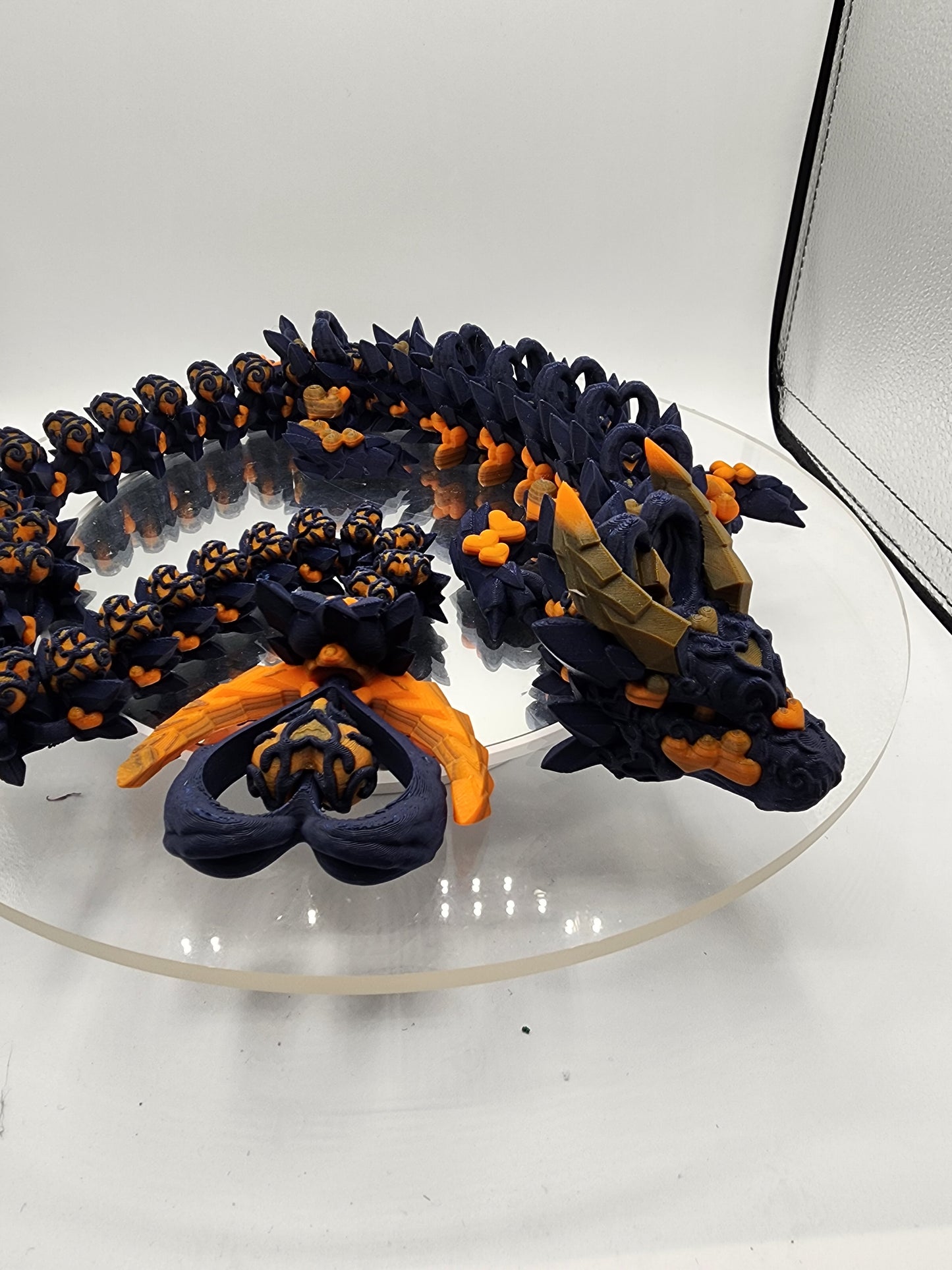 3D printed articulated Light Heart Dragon with custom color matching wall mount.