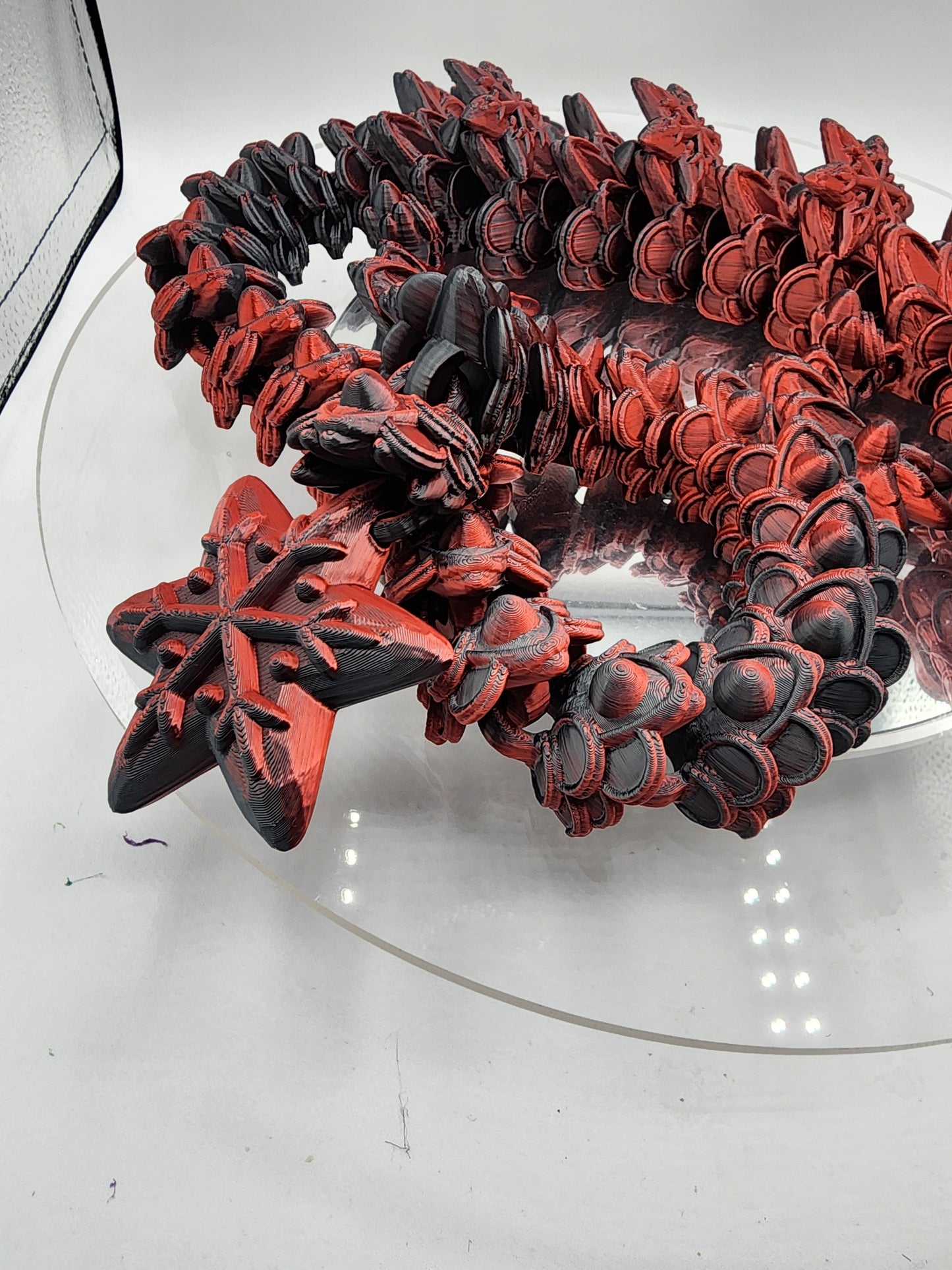 3D printed articulated color-changing Ginger Bread Dragon with wall mount.