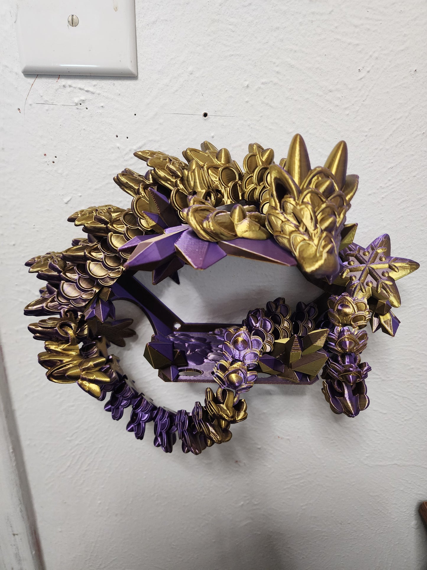 3D-printed, articulated color-changing Ginger Bread Dragon with custom wall mount.