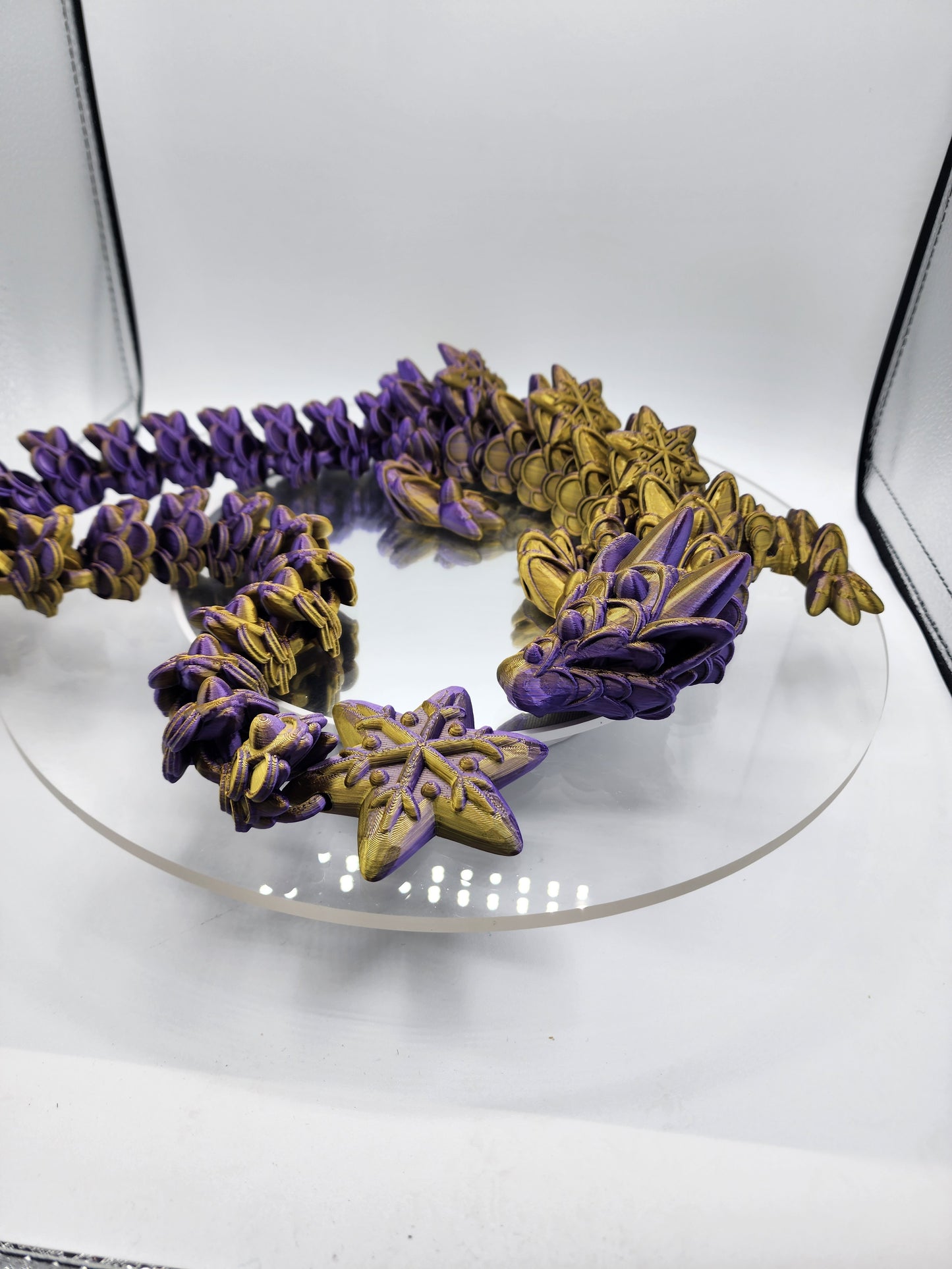 3D-printed, articulated color-changing Ginger Bread Dragon with custom wall mount.