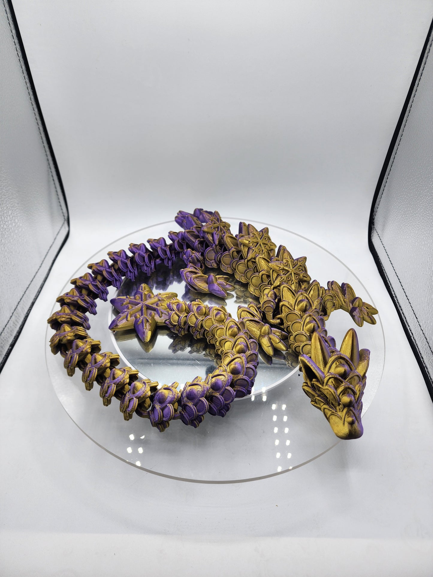 3D-printed, articulated color-changing Ginger Bread Dragon with custom wall mount.